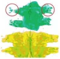 Foto eines Klecksbildes: Auf ein Papier wurden ein grüner und ein gelber Farbklecks gegeben und dieses dann in der Mitte gefaltet, sodass eine annähernd symmetrisches Bild entsteht. Bei dem grünen Bild sind die Ränder des Klecksbildes links und rechts nicht gleich (rechts ist es deutlich breiter).